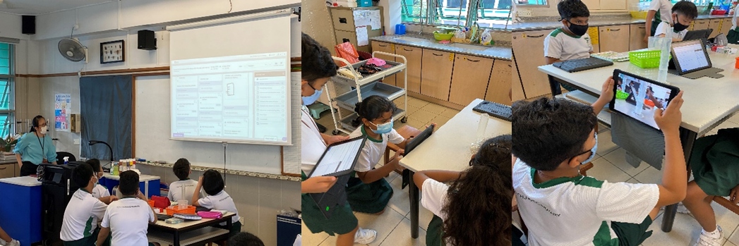 Students in uniforms and masks use tablets in a classroom while a teacher presents on a projector screen.